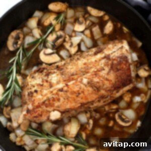 Pork tenderloin and gravy ingredients in skillet.