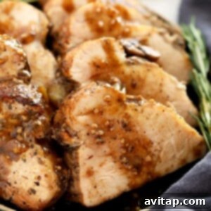 Sliced pork tenderloin with gravy on top.