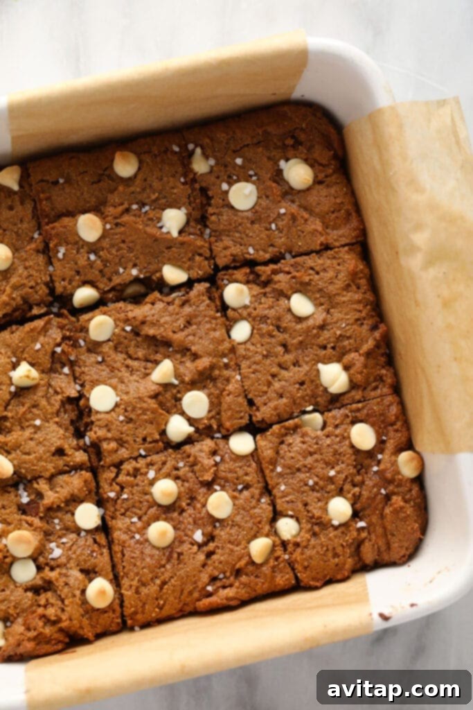 Freshly baked gingerbread cookie bars in a baking dish, perfectly cut into squares for serving.