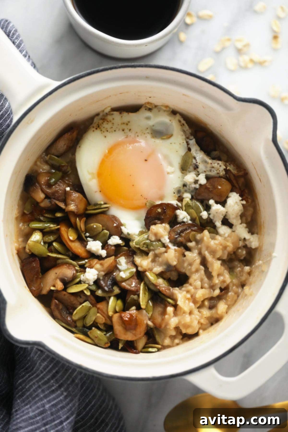 Delicious Savory Oatmeal 2 A comforting bowl of savory oatmeal topped with a golden-fried egg, perfectly sautéed mushrooms, and fresh herbs, ready for a healthy and satisfying breakfast.