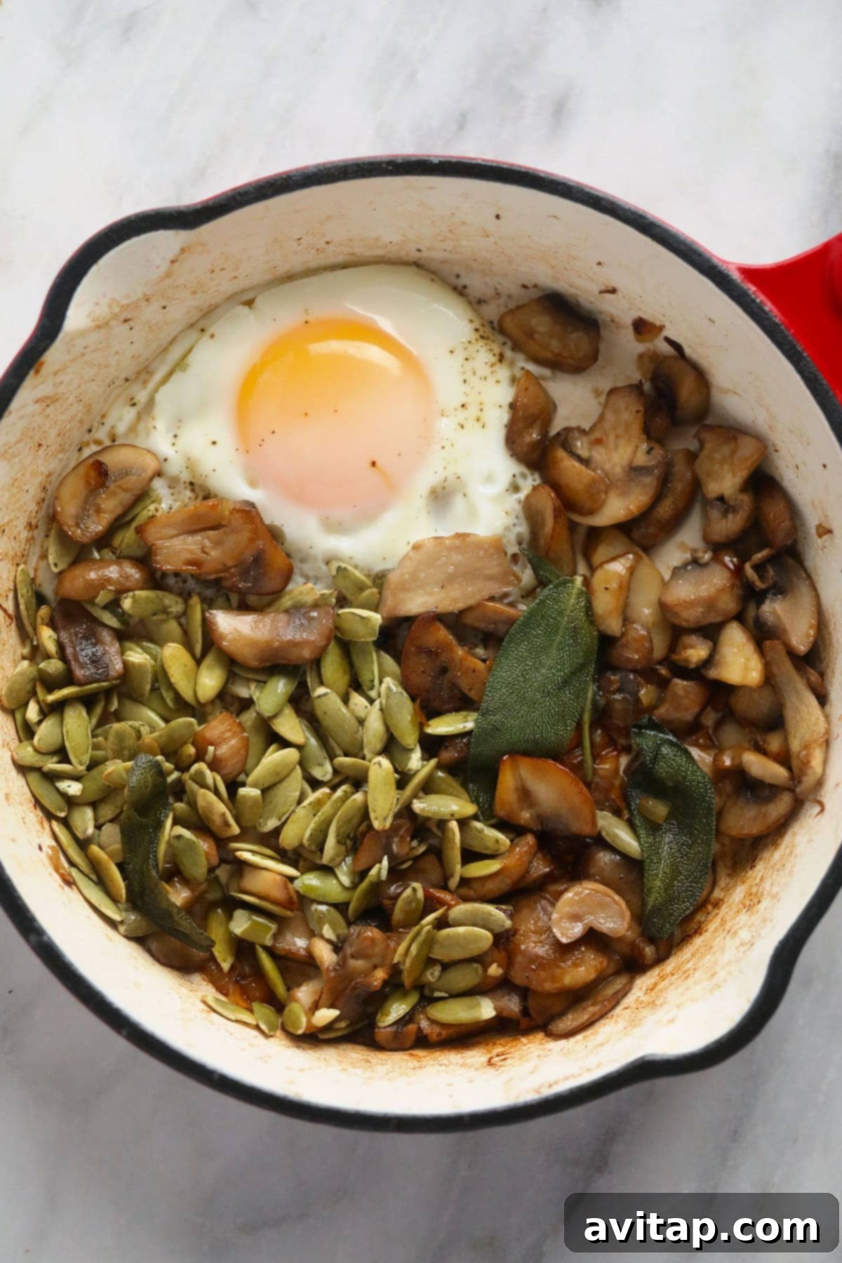 Delicious Savory Oatmeal 3 A small pot filled with savory oatmeal, beautifully adorned with a fried egg, sautéed mushrooms, and fresh herbs, showcasing a perfect savory breakfast meal.