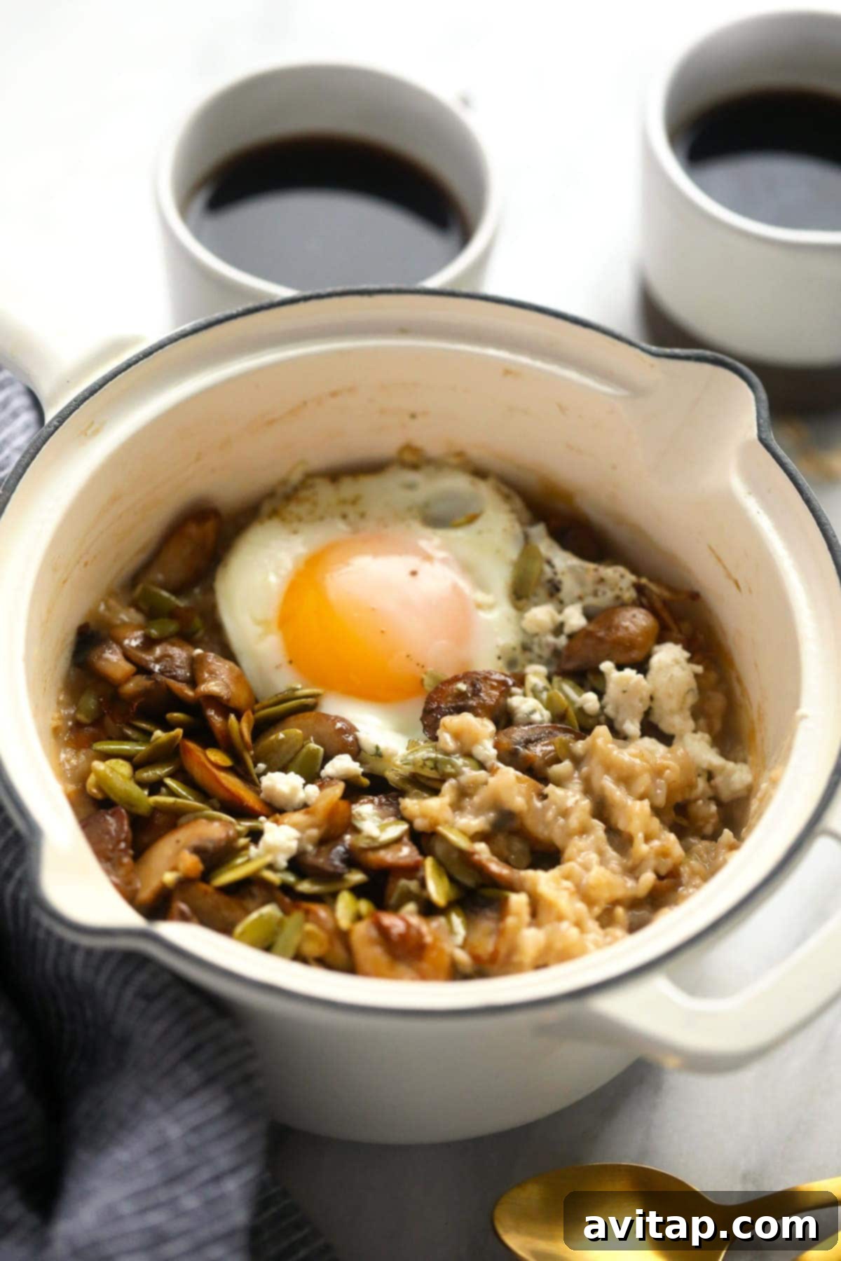 Delicious Savory Oatmeal 6 A beautifully plated bowl of savory oatmeal, elegantly crowned with a perfectly fried egg and garnished, showcasing a delicious and healthy breakfast.
