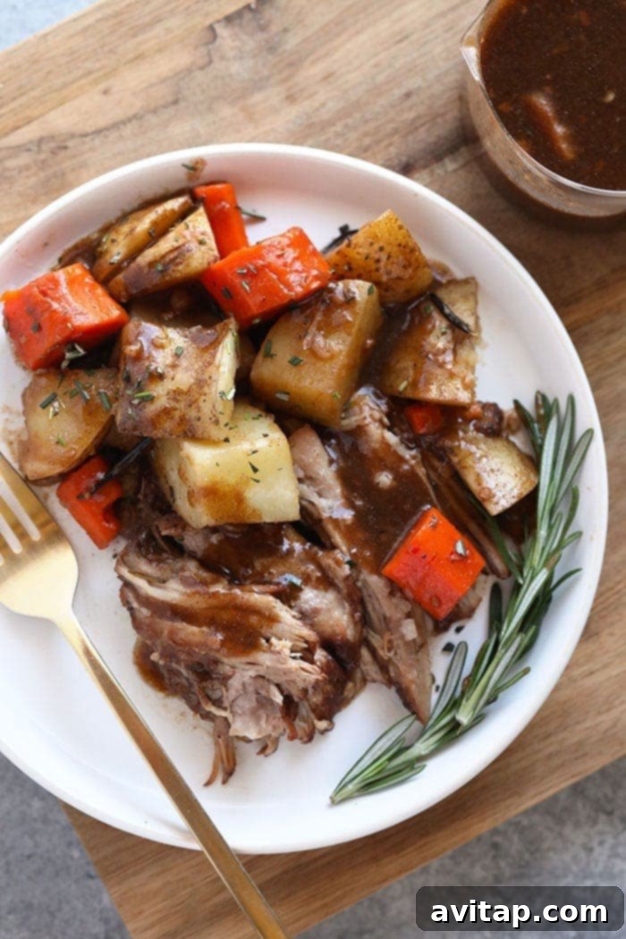 A comforting Instant Pot pork roast served with vegetables on a plate.
