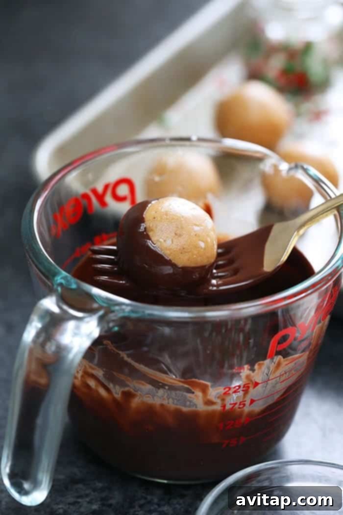 A measuring cup filled with rich, indulgent melted dark chocolate for dipping.