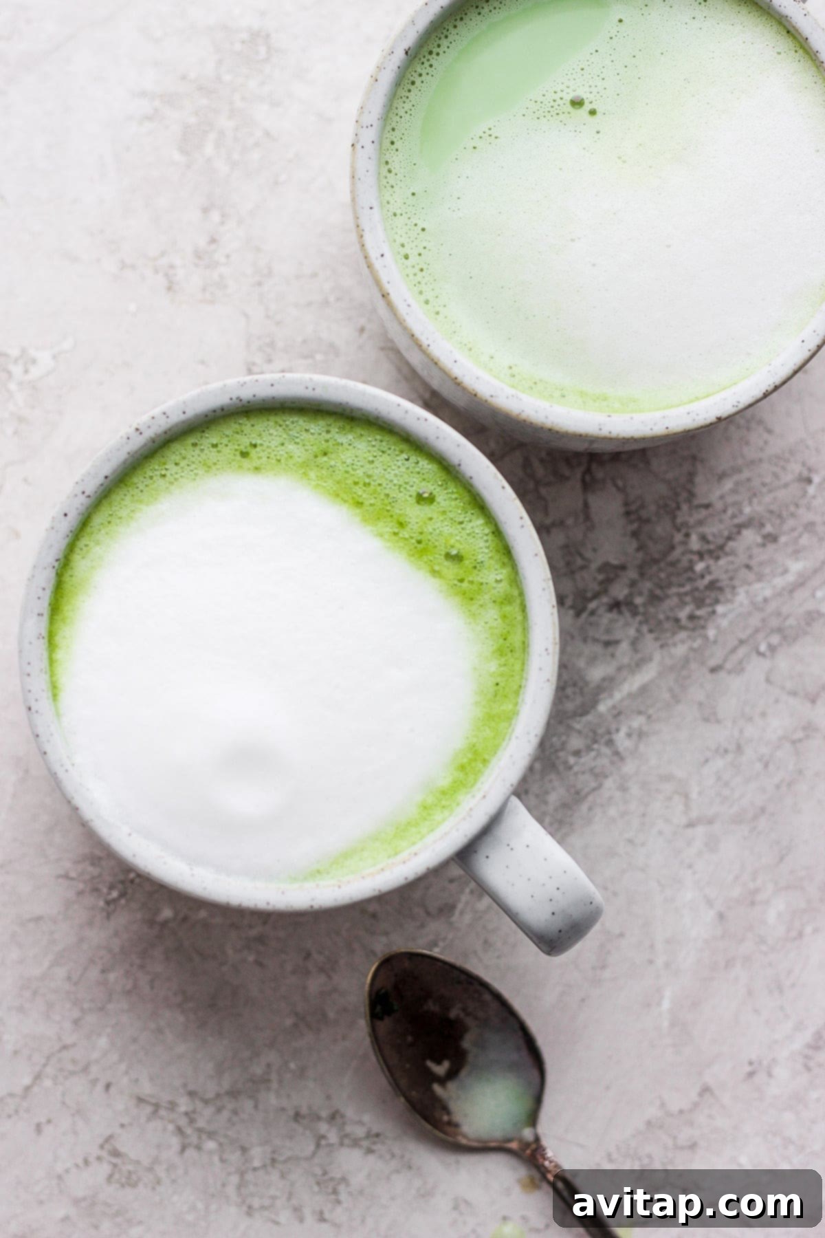 Matcha latte in a ceramic mug, ready to be enjoyed, showcasing its vibrant green color and creamy foam.