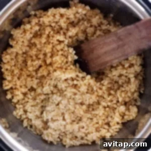 Brown rice in an instant pot with a wooden spoon.