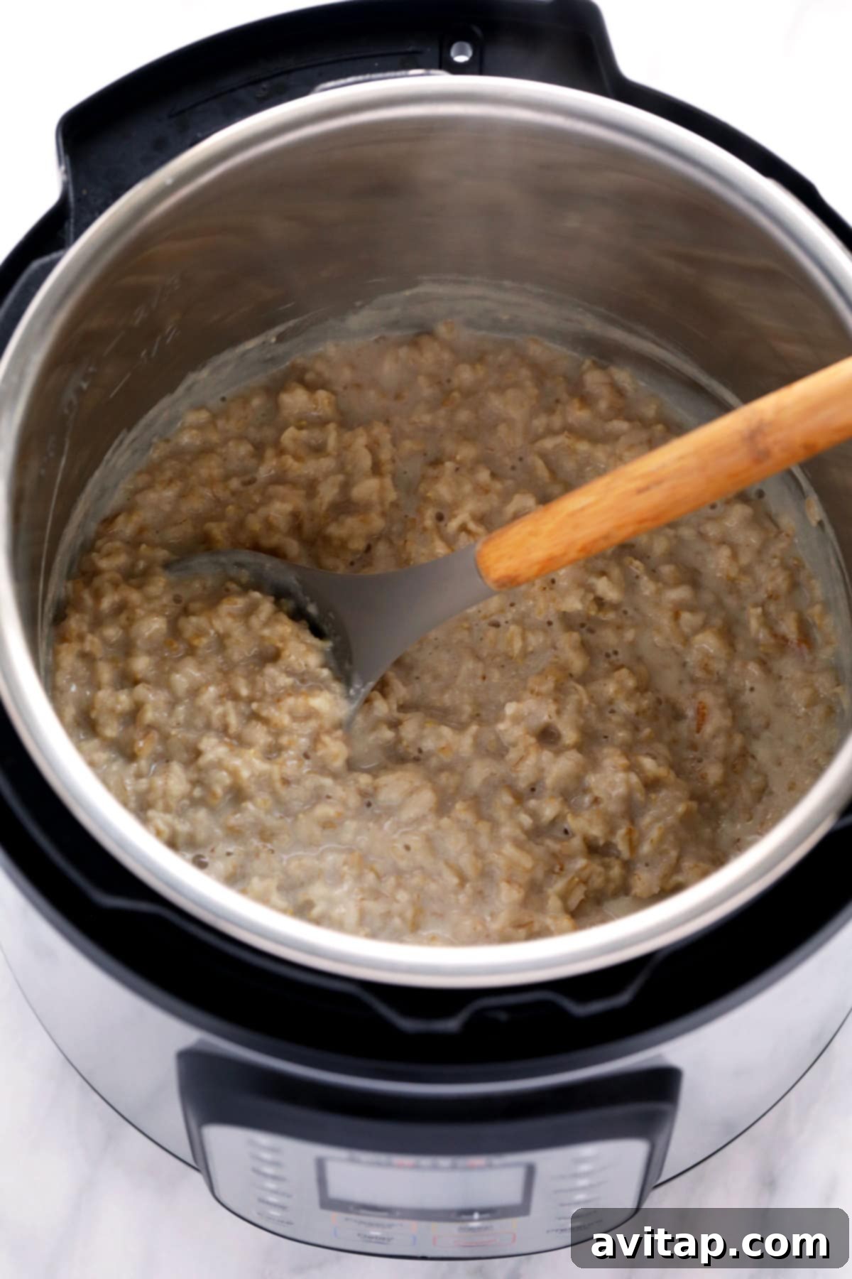 Instant Pot Oatmeal is a healthy breakfast packed with fiber and protein. This Instant Pot Oatmeal recipe is naturally vegan and gluten-free! A close-up shot of perfectly creamy Instant Pot oatmeal in a bowl.