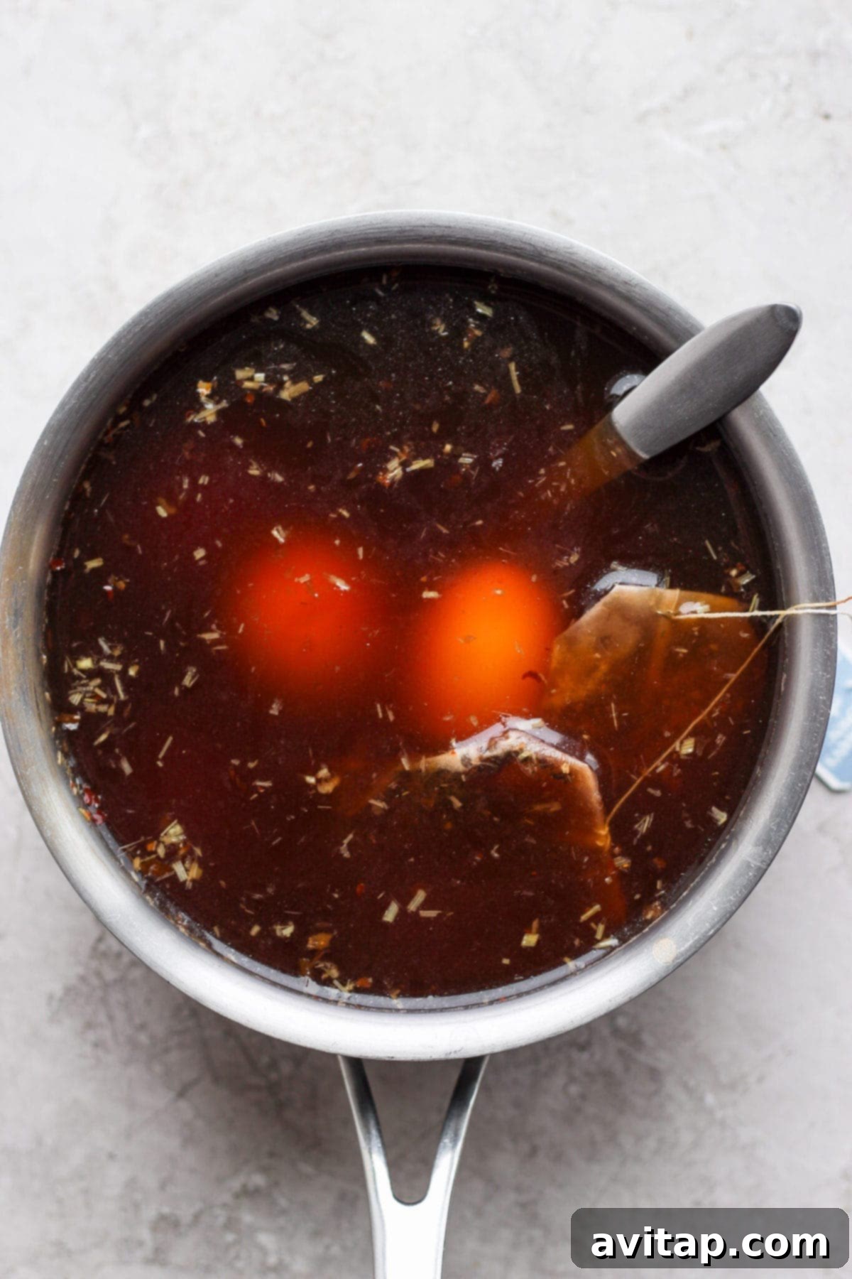 Perfectly soft-boiled ramen eggs soaking in a rich, dark marinade, ready to infuse with flavor.
