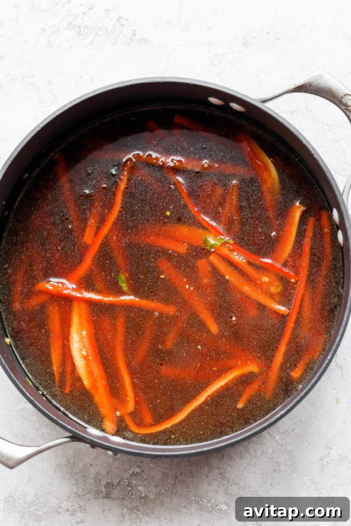 A simmering pot of flavorful ramen broth, rich with vegetables and aromatics, hinting at a delicious and satisfying meal.