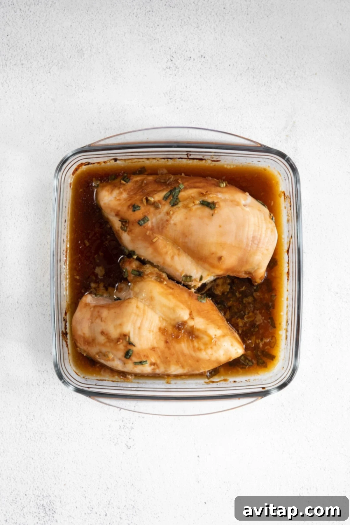 Perfectly cooked teriyaki chicken breast in a casserole dish, glistening with sauce and ready to be served