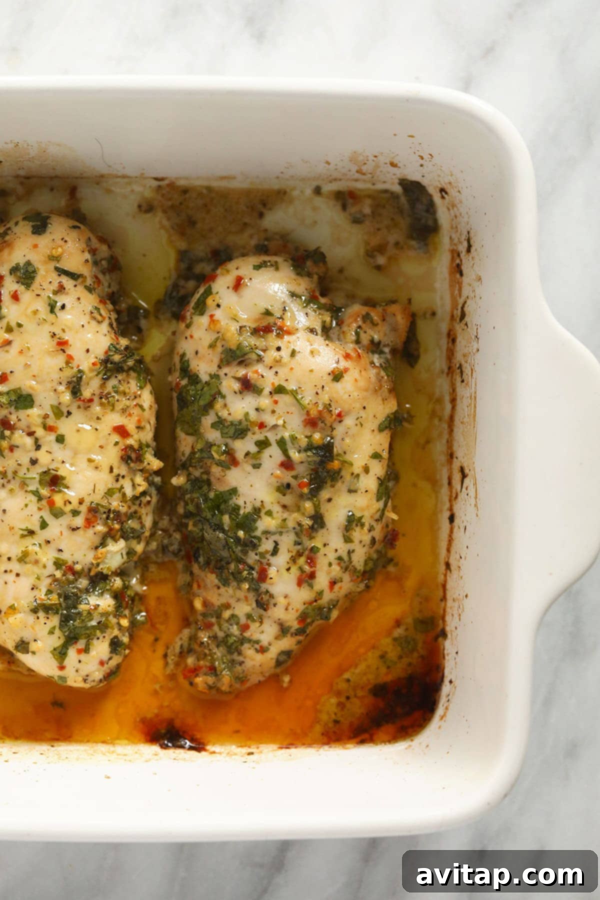 Baked Italian chicken breast in a casserole dish, marinated to perfection.