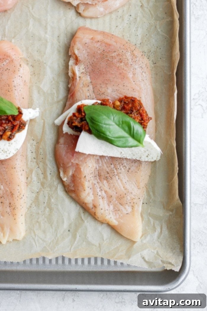 A succulent chicken breast topped with melted mozzarella cheese and fresh basil, showcasing a healthy and flavorful meal.