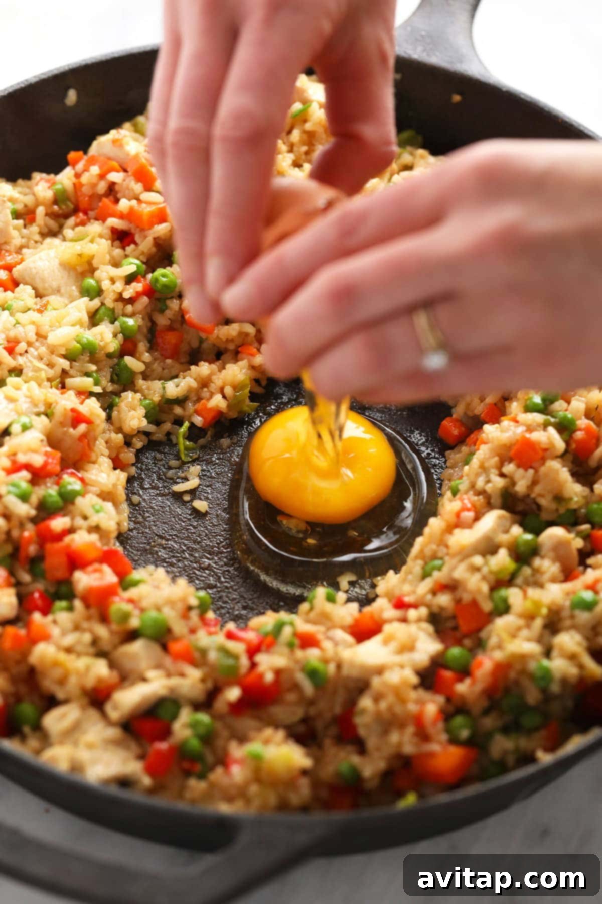 Cracking fresh eggs directly into the middle of a hot frying pan, ready to be scrambled