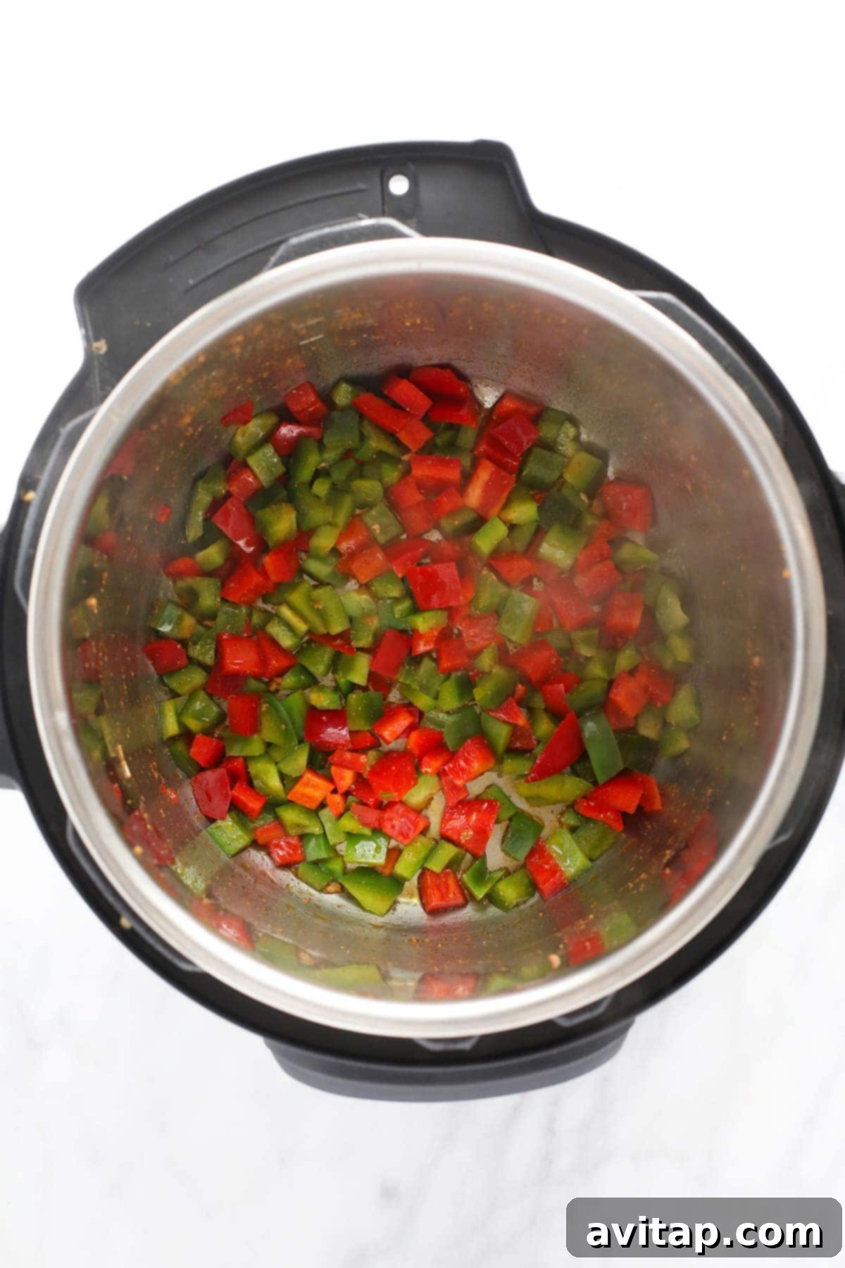 Quick Instant Pot Burrito Bowls 3 Sautéed red and green bell peppers in the Instant Pot, forming a vibrant base for Instant Pot Burrito Bowls