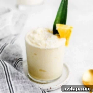 A perfectly blended piña colada in a glass, ready to be enjoyed.