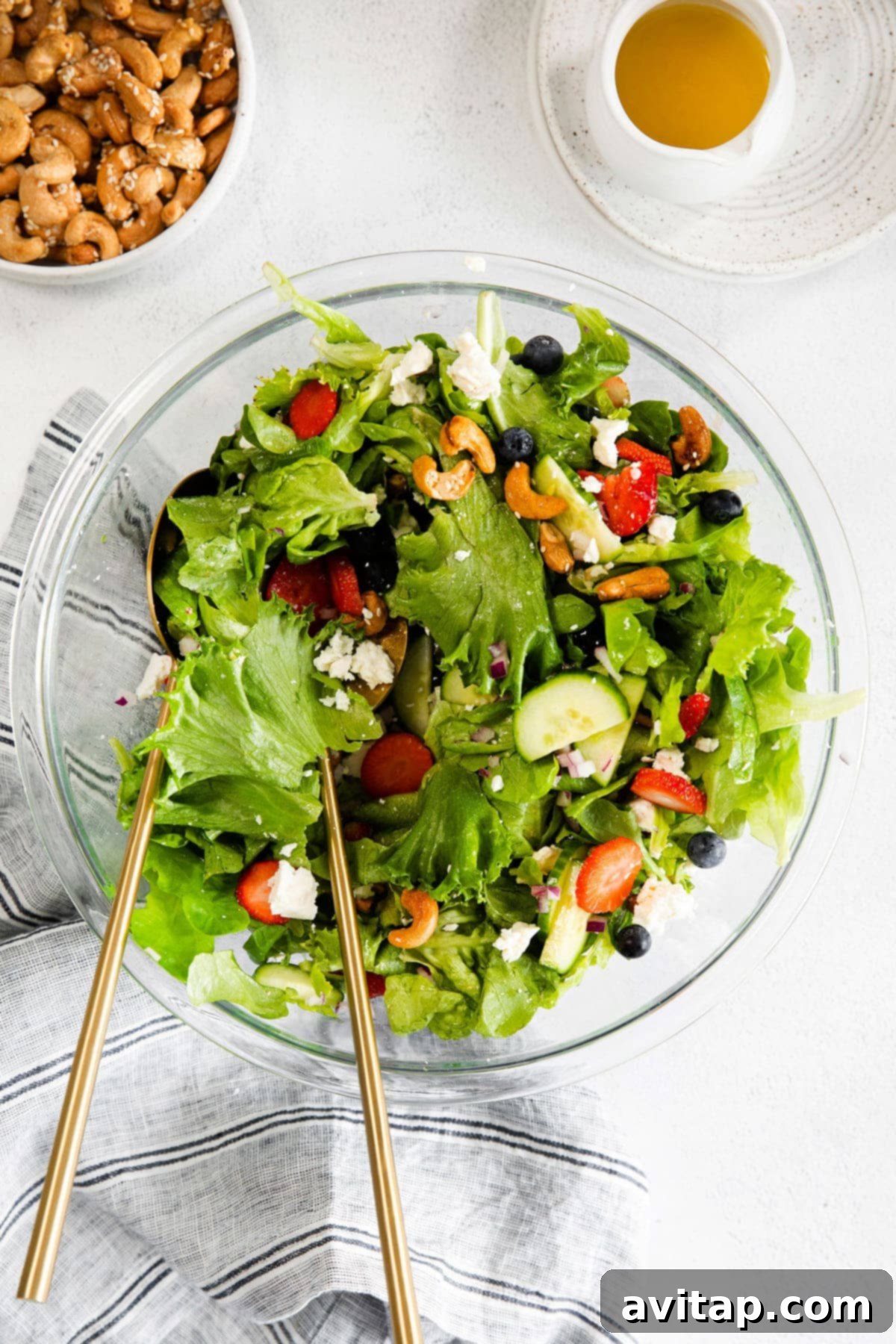 A large, vibrant spring mix salad in a beautiful serving bowl, ready to be enjoyed.