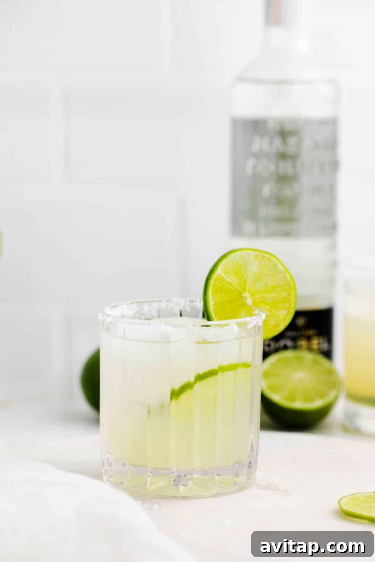The Perfect Margarita 2 A classic margarita in a glass, garnished with a lime wedge.