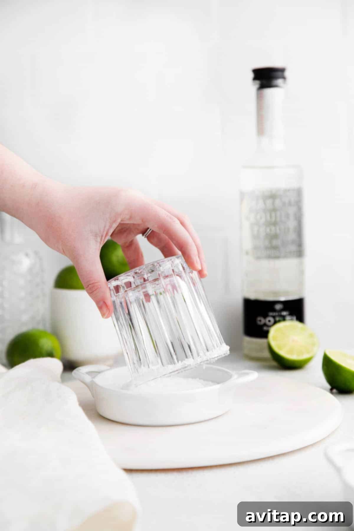 The Perfect Margarita 4 Dipping the rim of a margarita glass into salt.