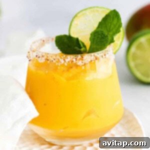 A vibrant mango margarita in a glass, ready to be enjoyed.