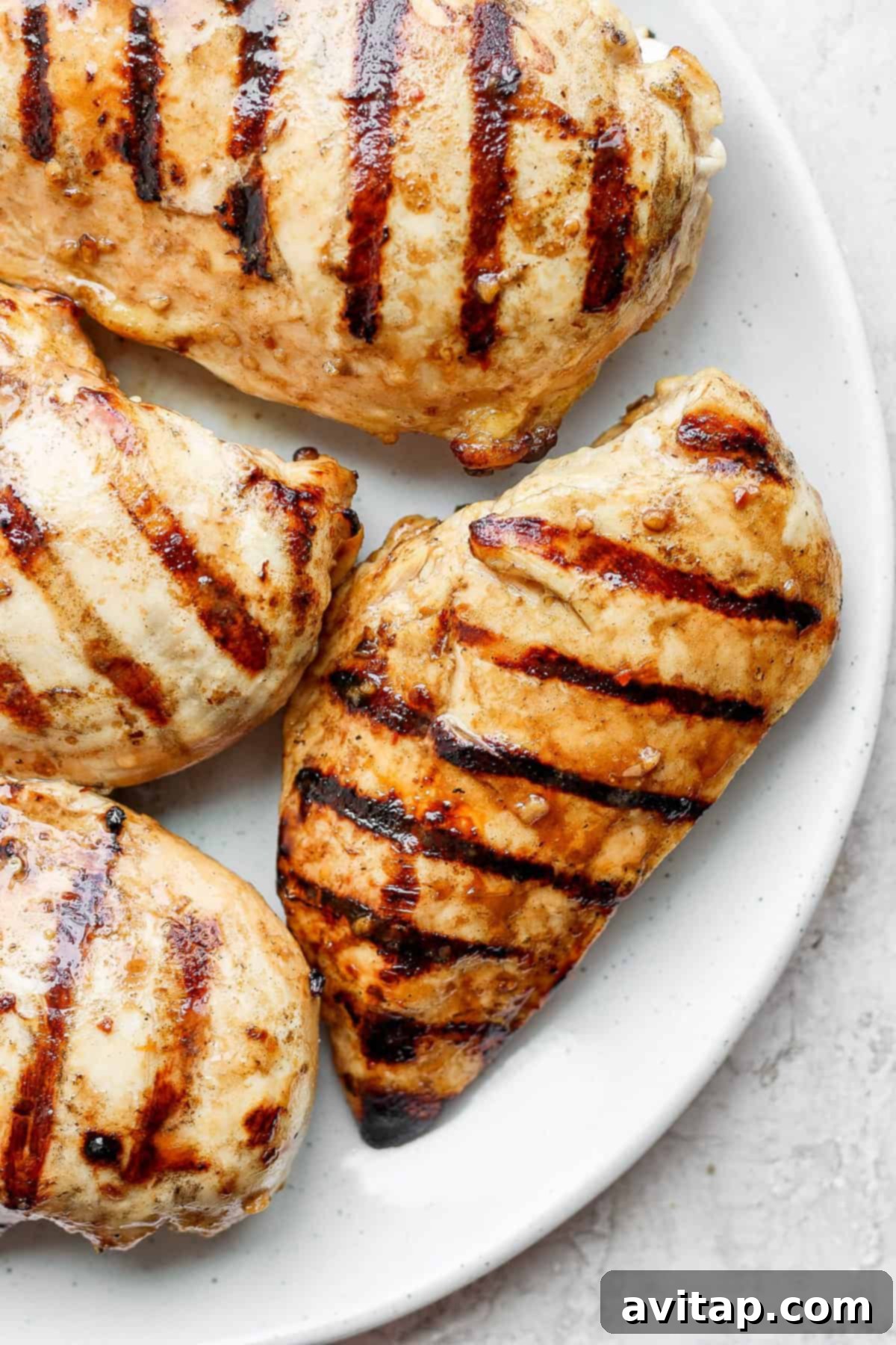 Perfectly grilled chicken on a plate, ready to be served.