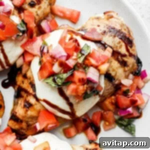 a white plate topped with meat covered in toppings.