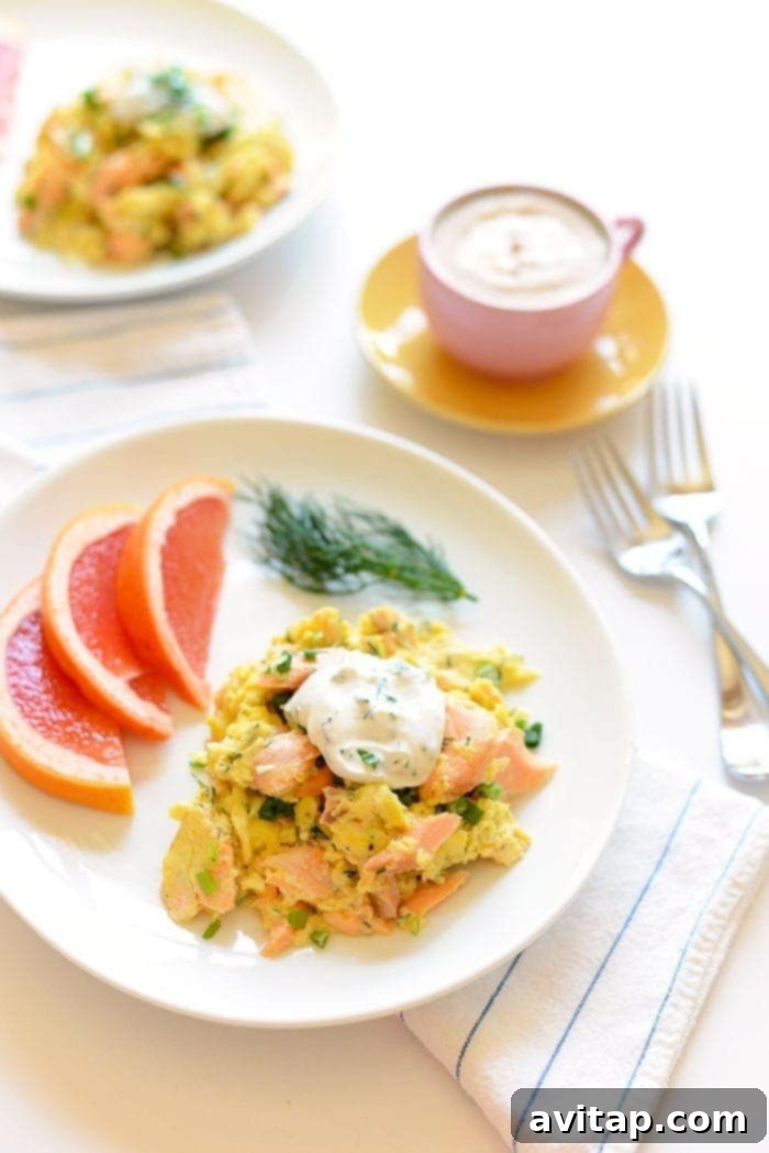 Protein-Packed Dill Salmon Eggs Scramble A vibrant dill salmon and eggs scramble served on a plate, garnished with fresh dill.