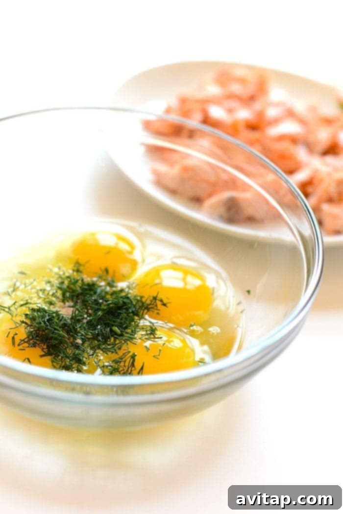 Fresh Eggs and Dill Fresh eggs cracked into a bowl with vibrant green dill sprigs.