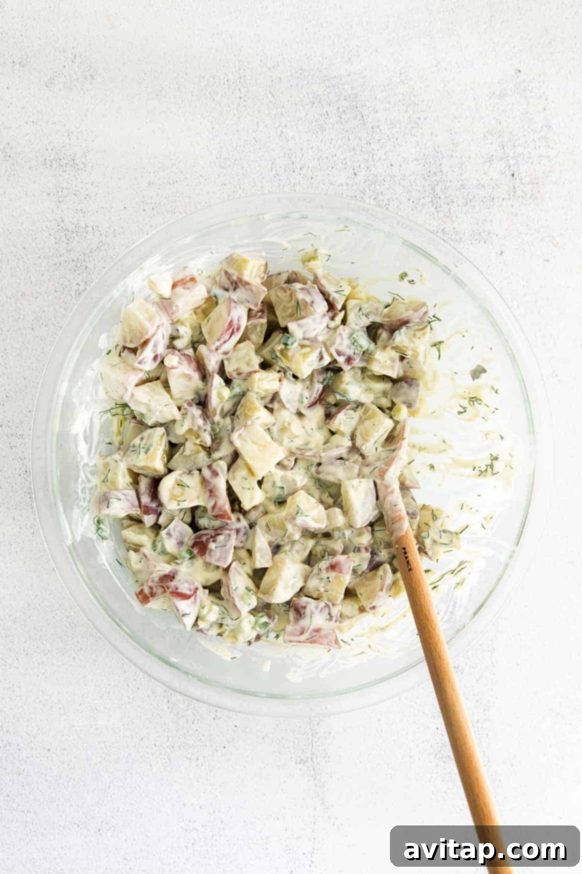 A large bowl of delicious red potato salad, perfectly tossed and ready to serve.