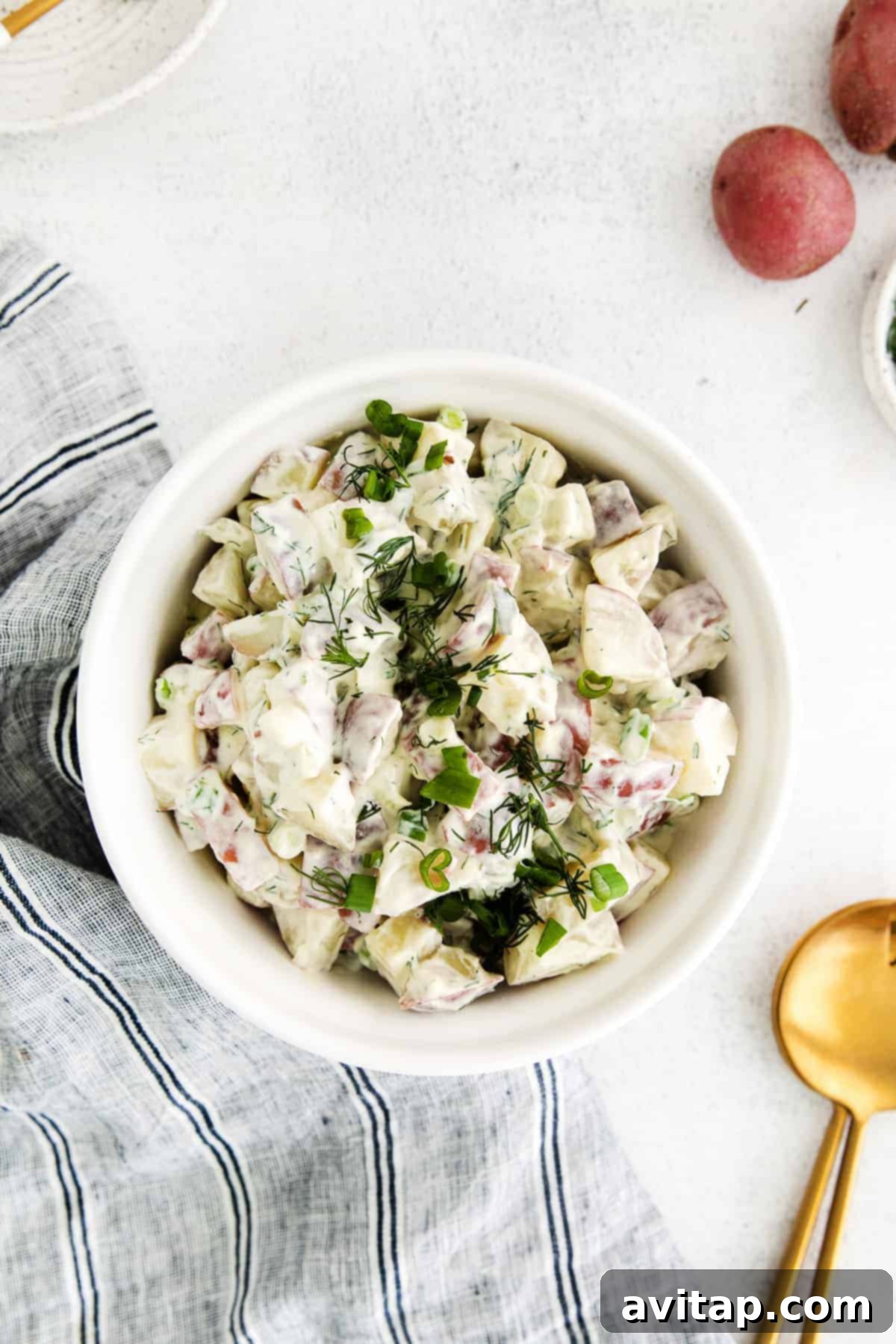 A large bowl of red potato salad ready for serving.