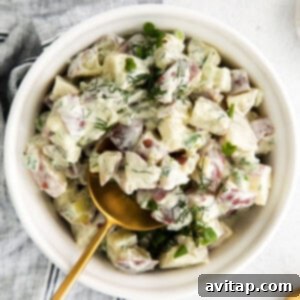 A bowl of creamy red potato salad.