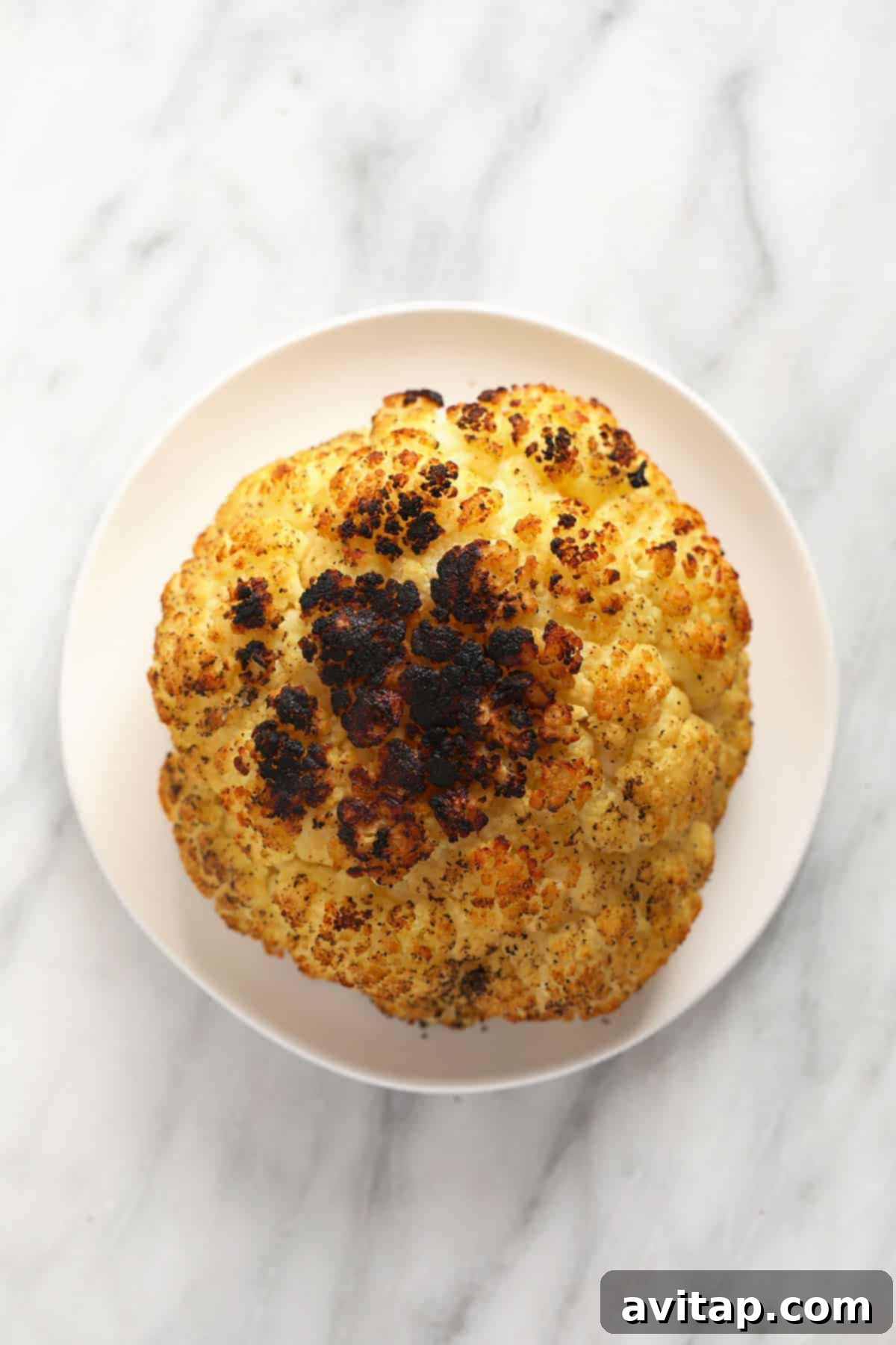 A stunning plate of grilled cauliflower, showcasing beautiful char marks and a golden hue, making a perfect healthy side.