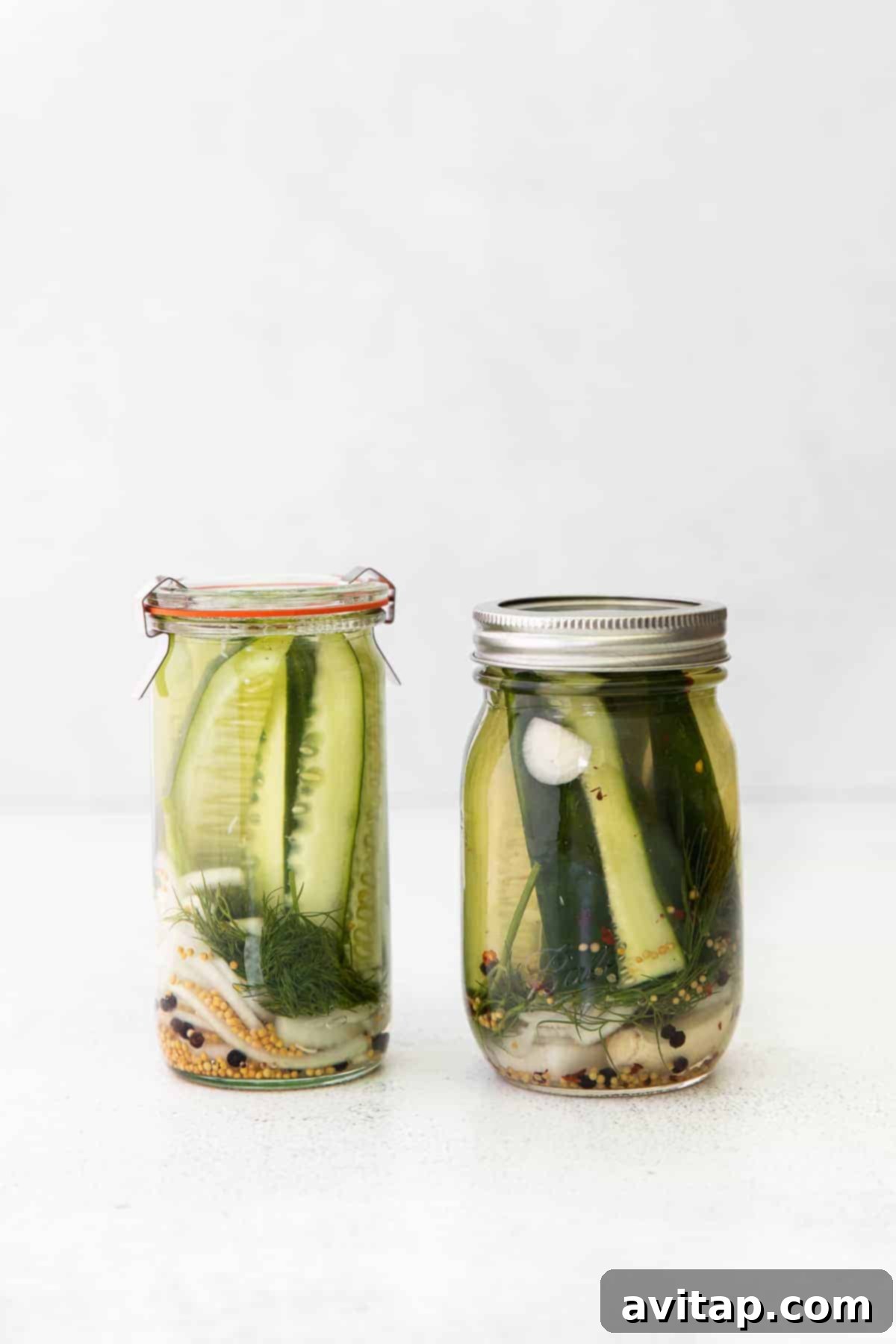 Freshly poured brine over cucumbers in a mason jar, illustrating the pickling process.