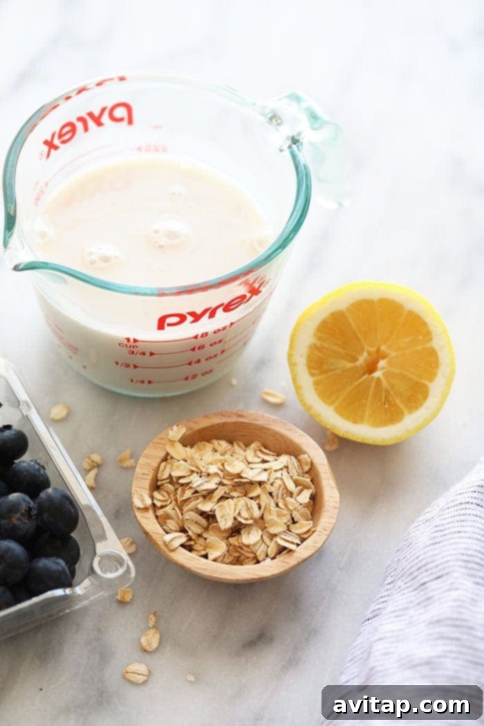 almond milk, rolled oats, lemon, and blueberries on countertop