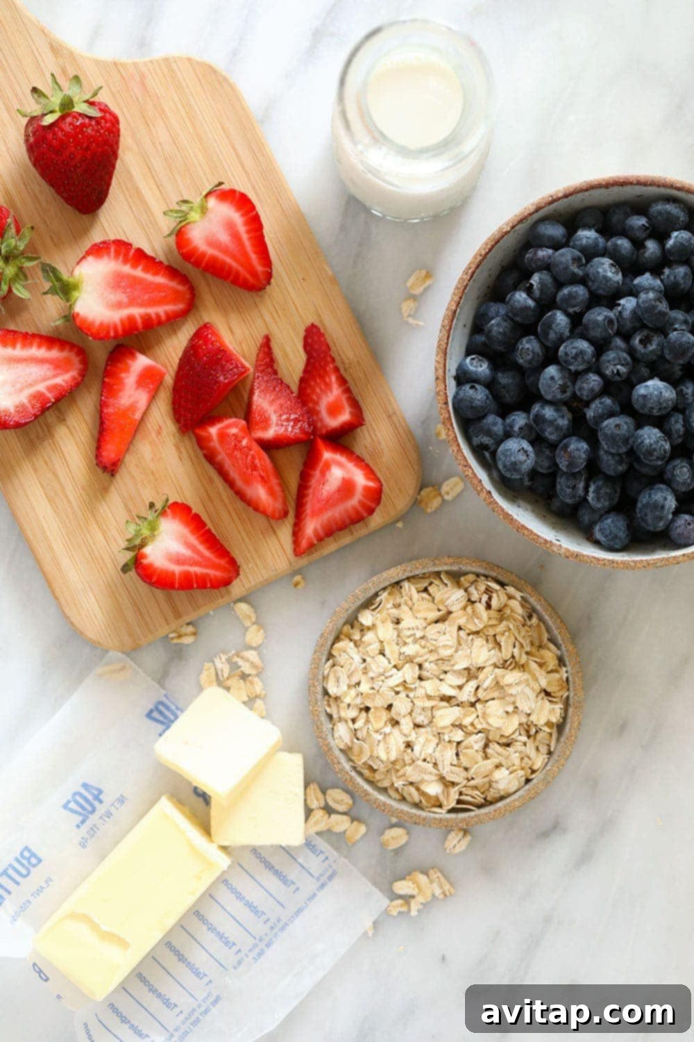rolled oats, sliced strawberries, butter, milk, and blueberries