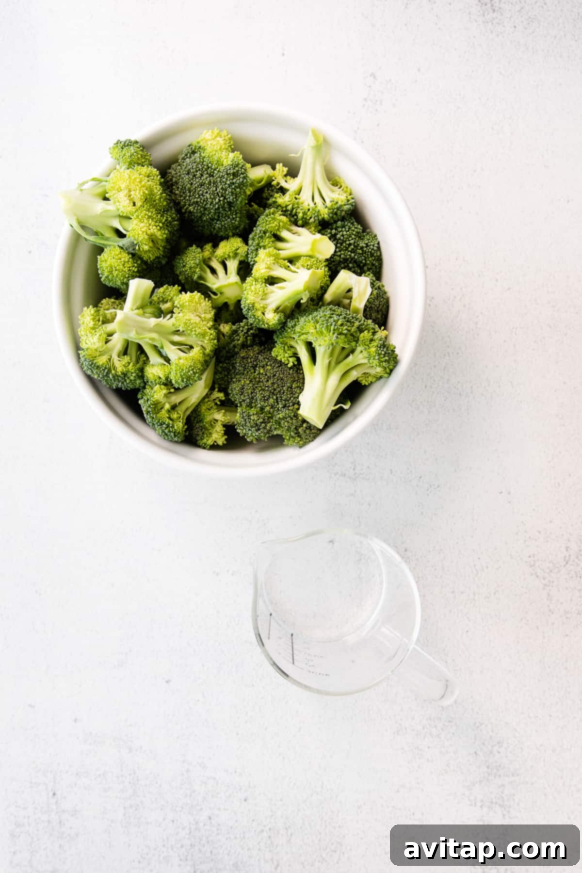 broccoli in bowl and water in cup
