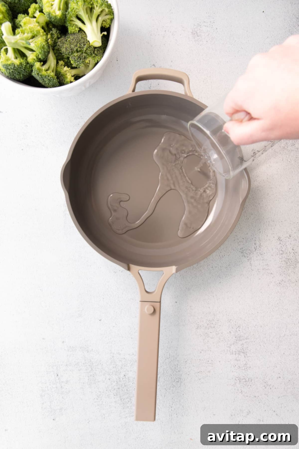 pouring water into pan