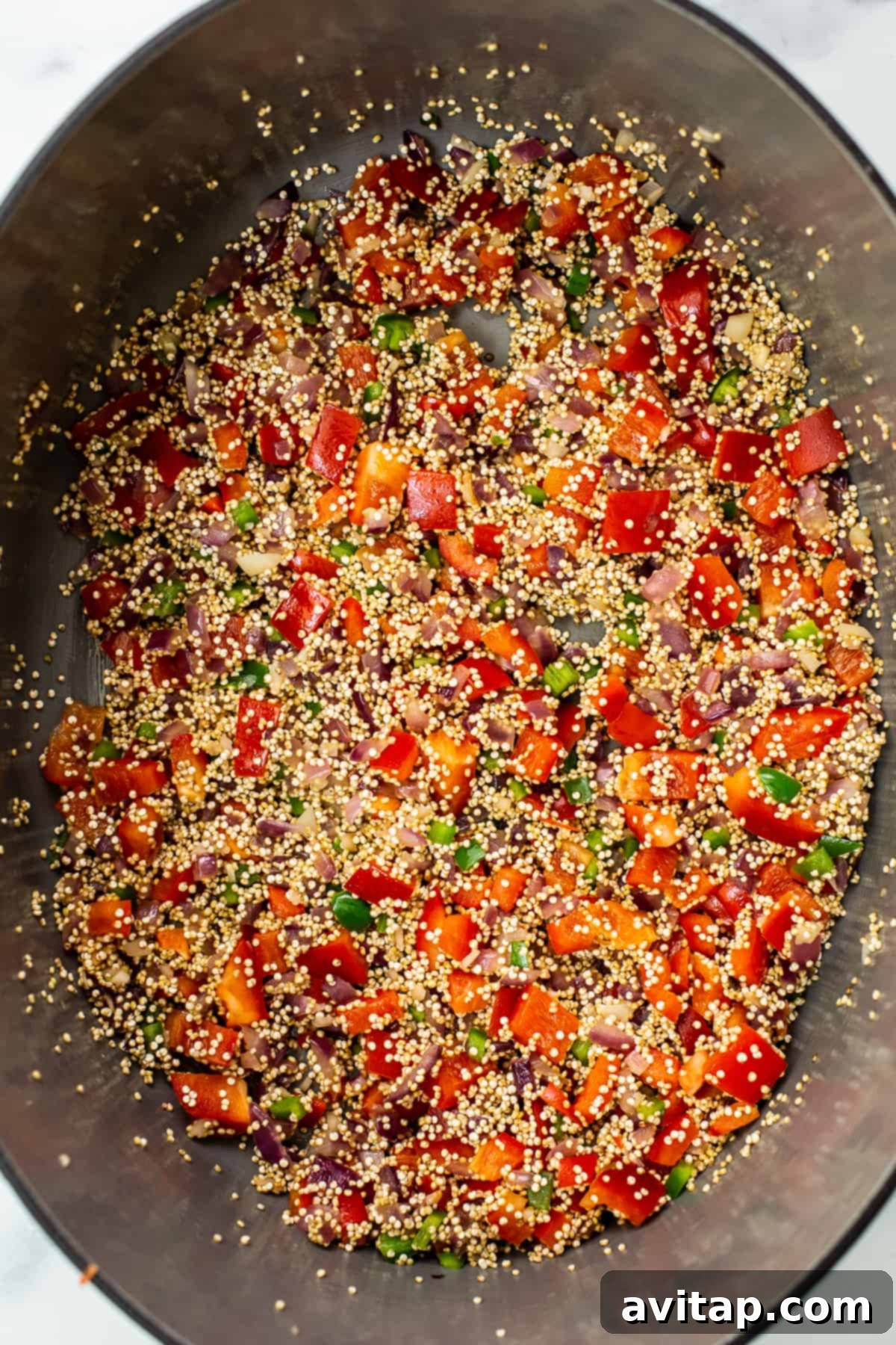 A large Dutch oven filled with colorful quinoa chili simmering gently on the stovetop, showcasing the rich texture and vibrant ingredients.