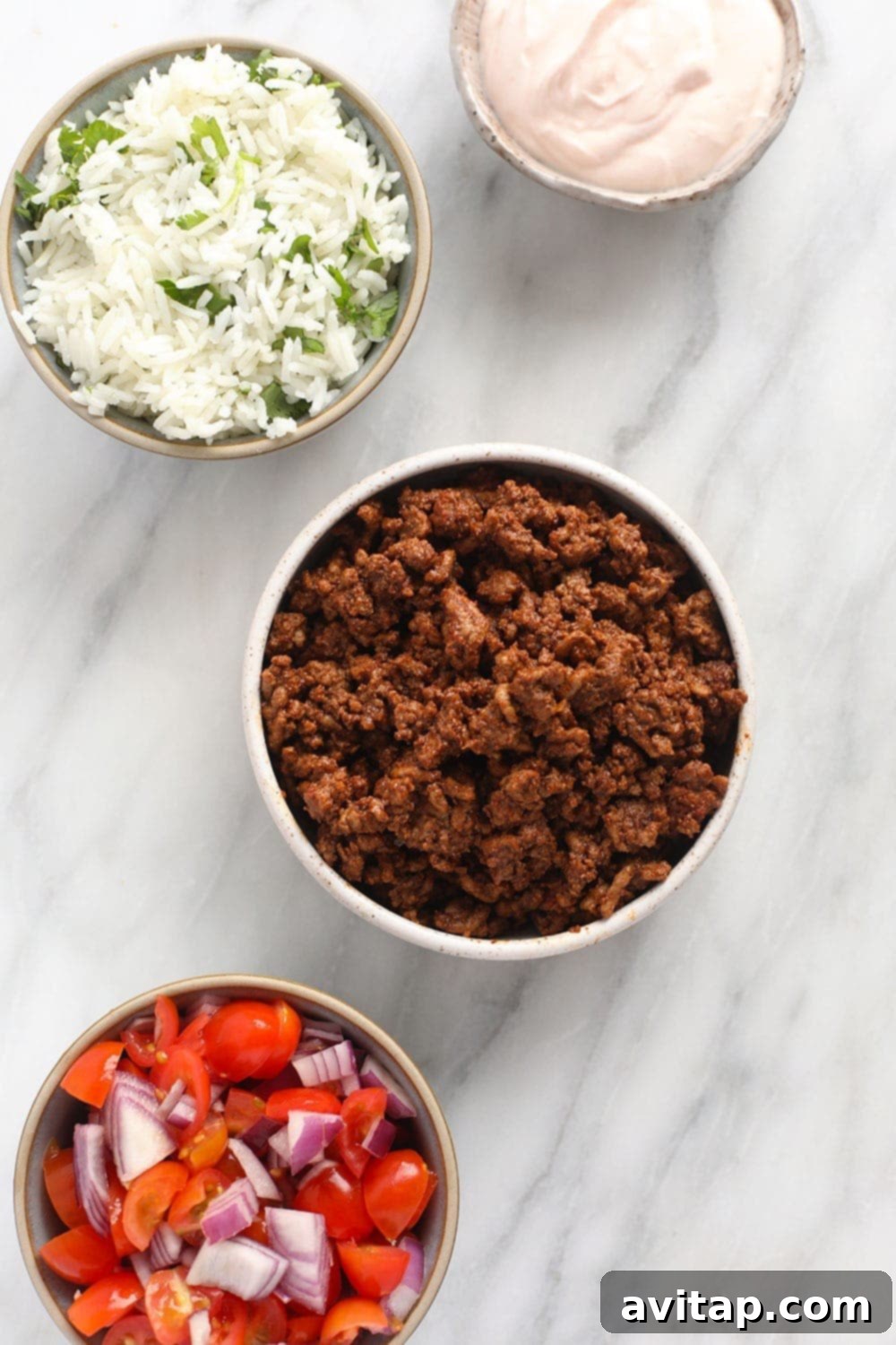 Fresh ingredients laid out for building healthy taco bowls.
