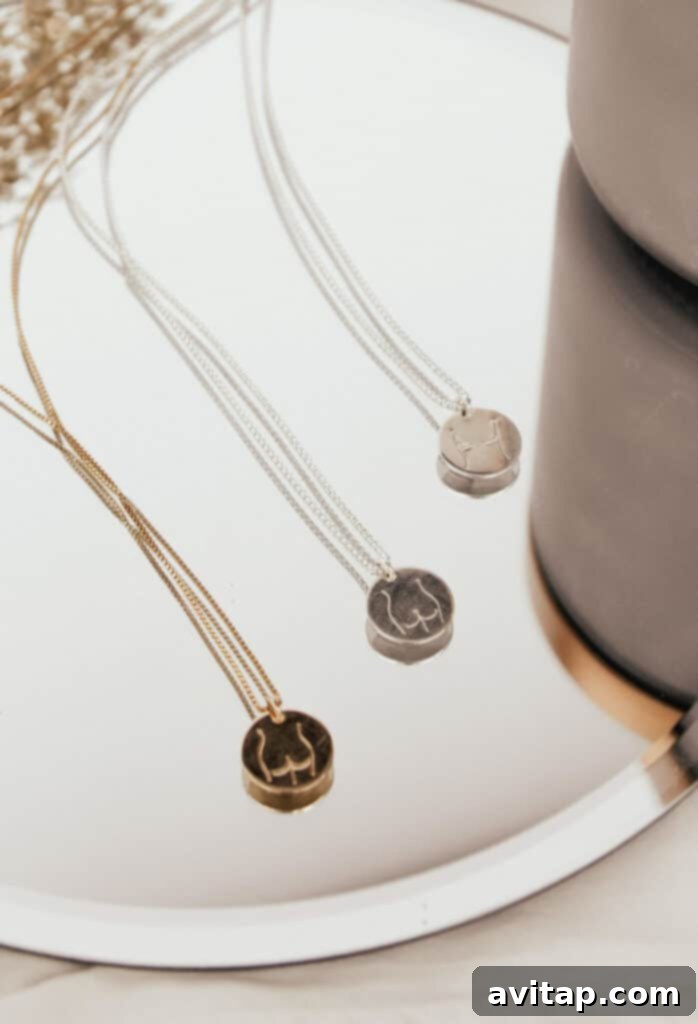 A beautifully arranged flat lay of Femme Collection jewelry, featuring various pendant shapes and chain styles, emphasizing the handcrafted quality.