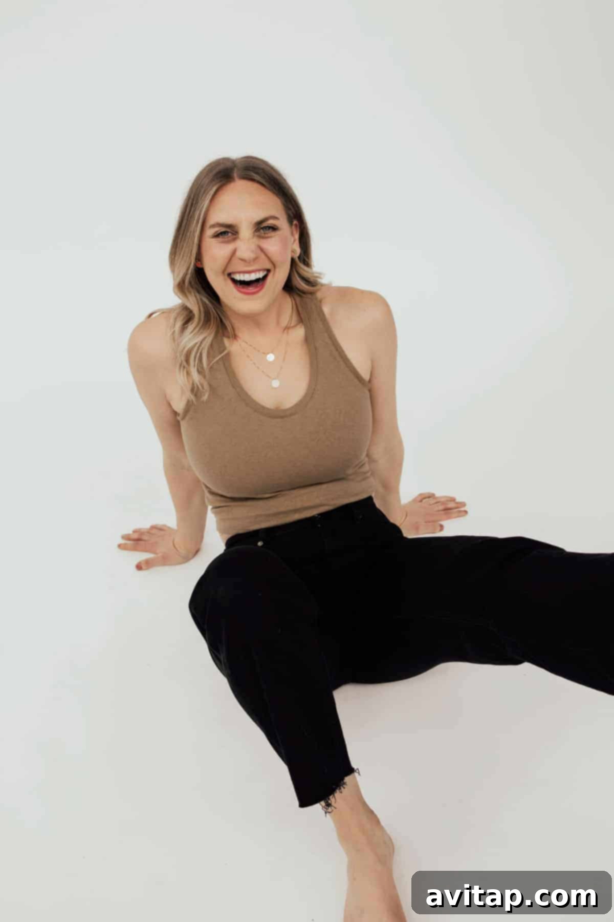 Lee Funke, co-founder of Fit Foodie Finds, proudly wearing a selection of necklaces from The Femme Collection, exuding confidence and grace.