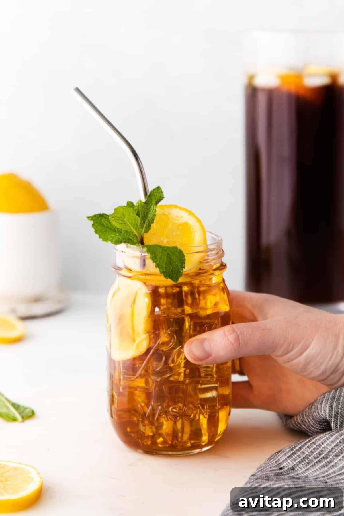 The Best Homemade Iced Tea Recipe homemade iced tea in a mason jar garnished with mint and a lemon slice
