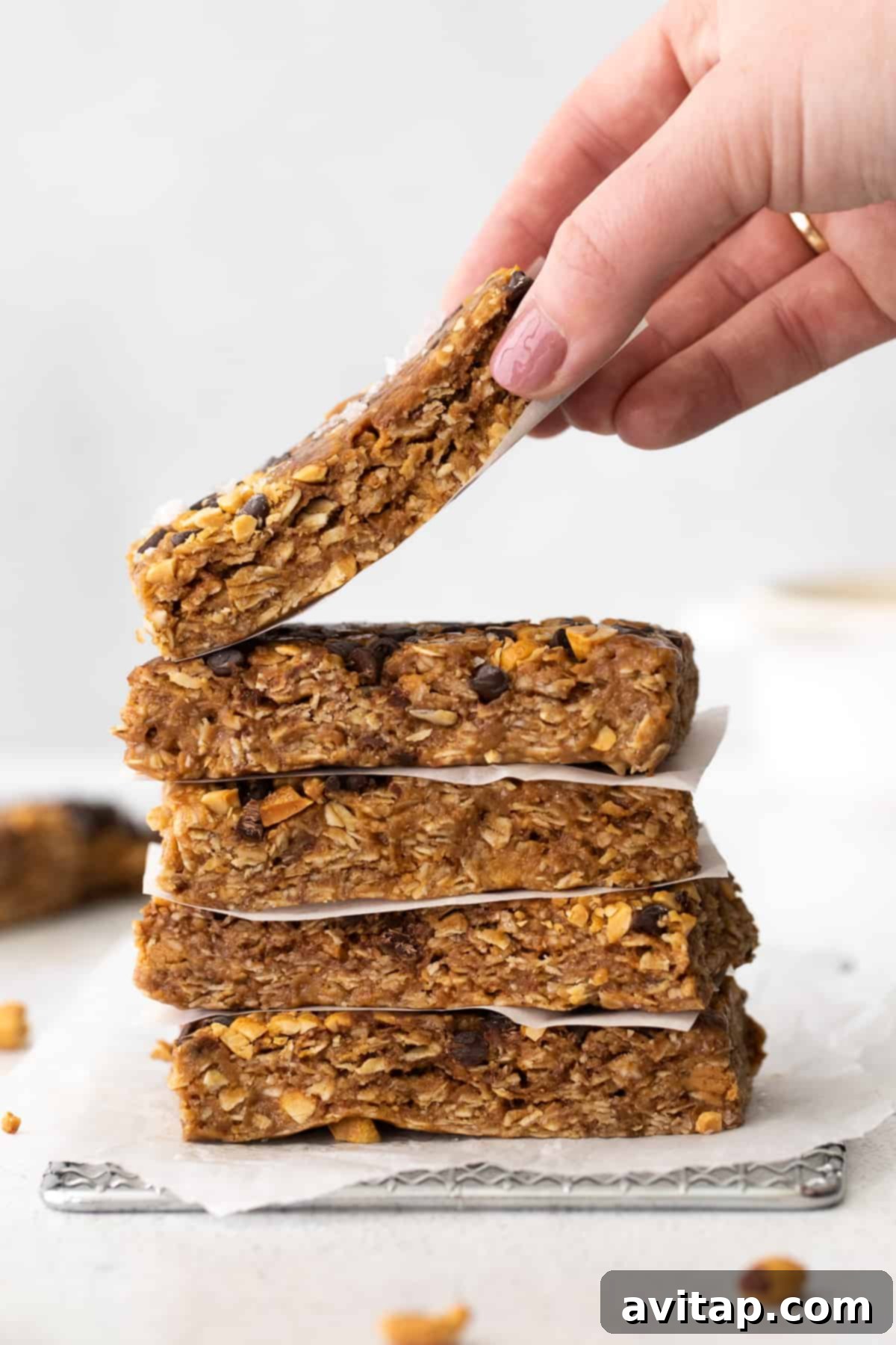 Hand holding a delicious homemade peanut butter chocolate chip granola bar