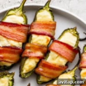 Bacon wrapped jalapenos on a plate.