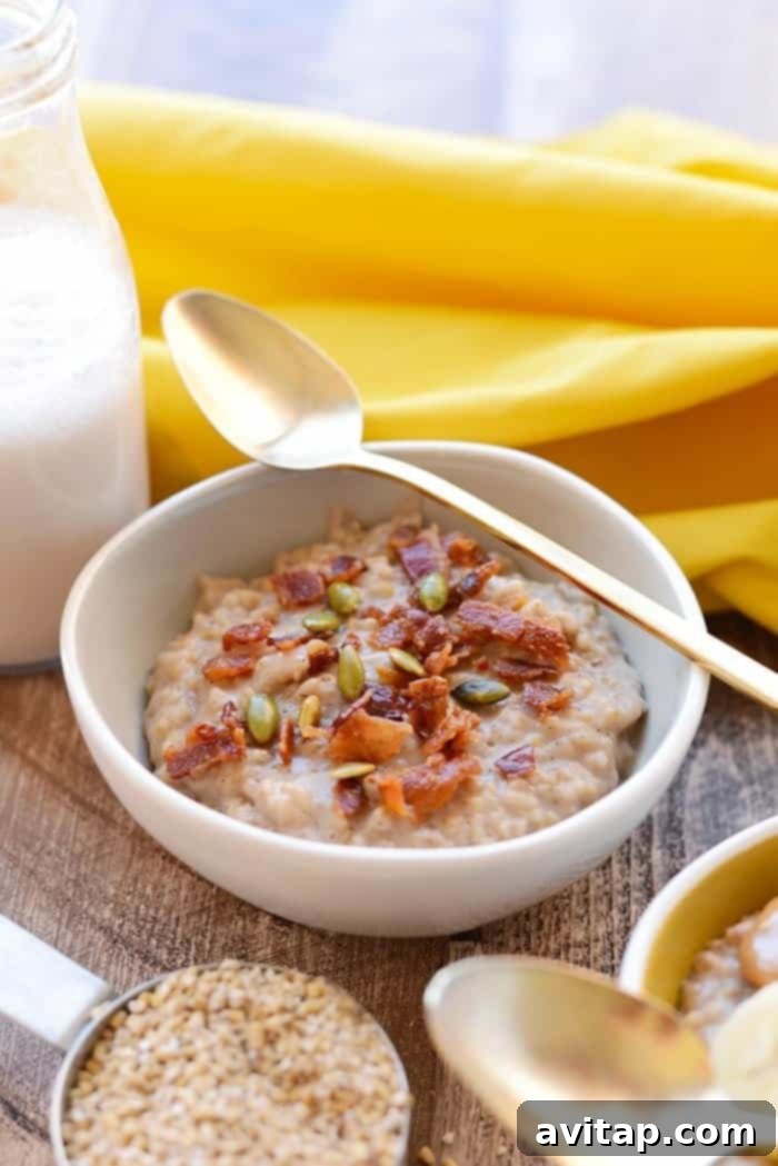 Four individual bowls of Crockpot Steel Cut Oats, ready to be customized with toppings, illustrating a perfect meal prep solution.