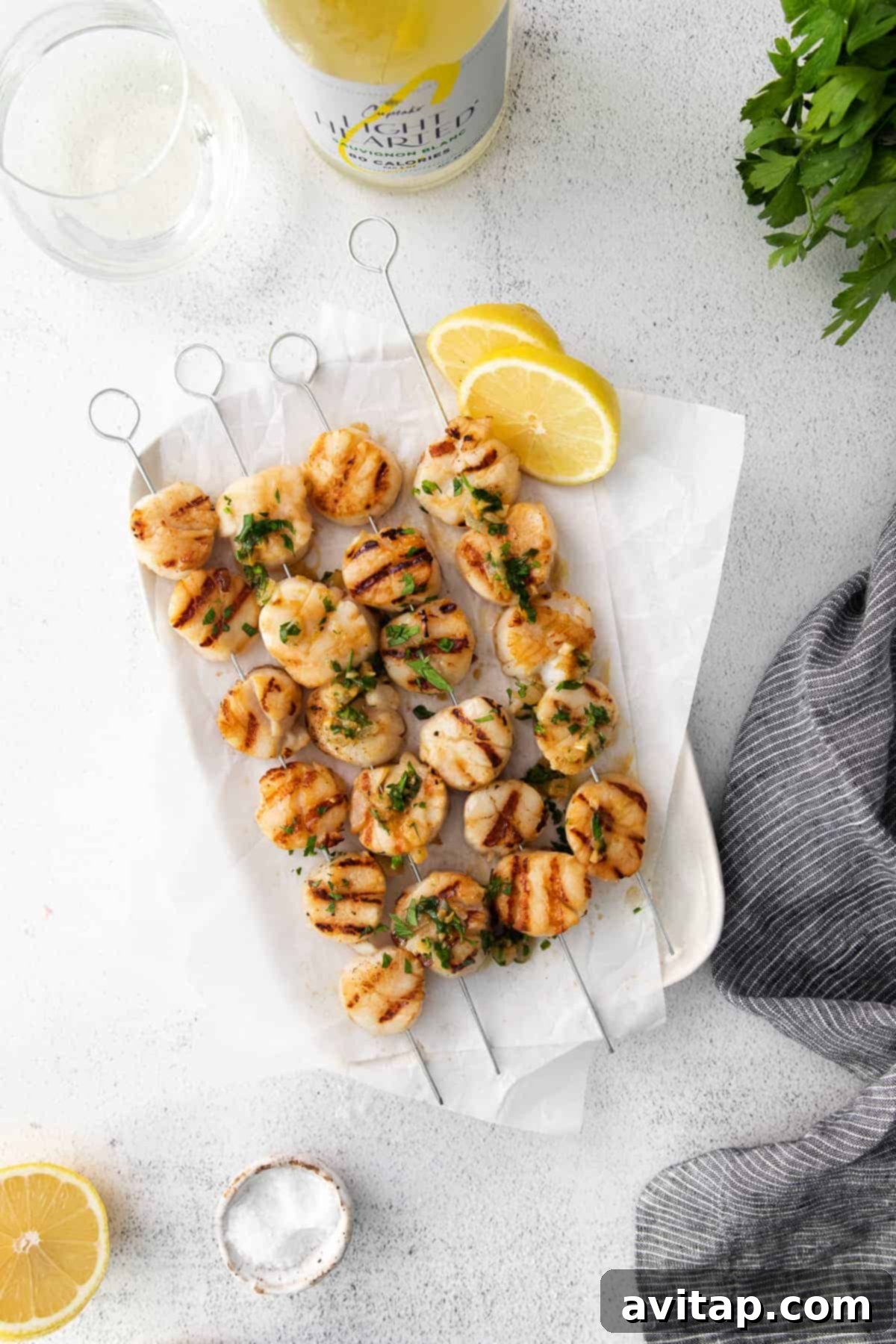 Perfectly grilled scallops on skewers, glistening with marinade.