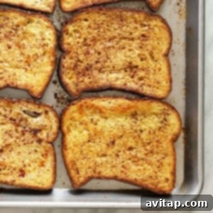 Sliced French toast on a baking sheet, ready for serving.