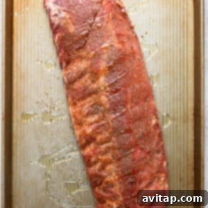 Fall-Off-The-Bone Oven Ribs 7 Ribs on a baking sheet covered with foil.