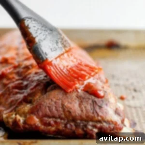 Fall-Off-The-Bone Oven Ribs 8 Slathering BBQ sauce onto tender ribs.