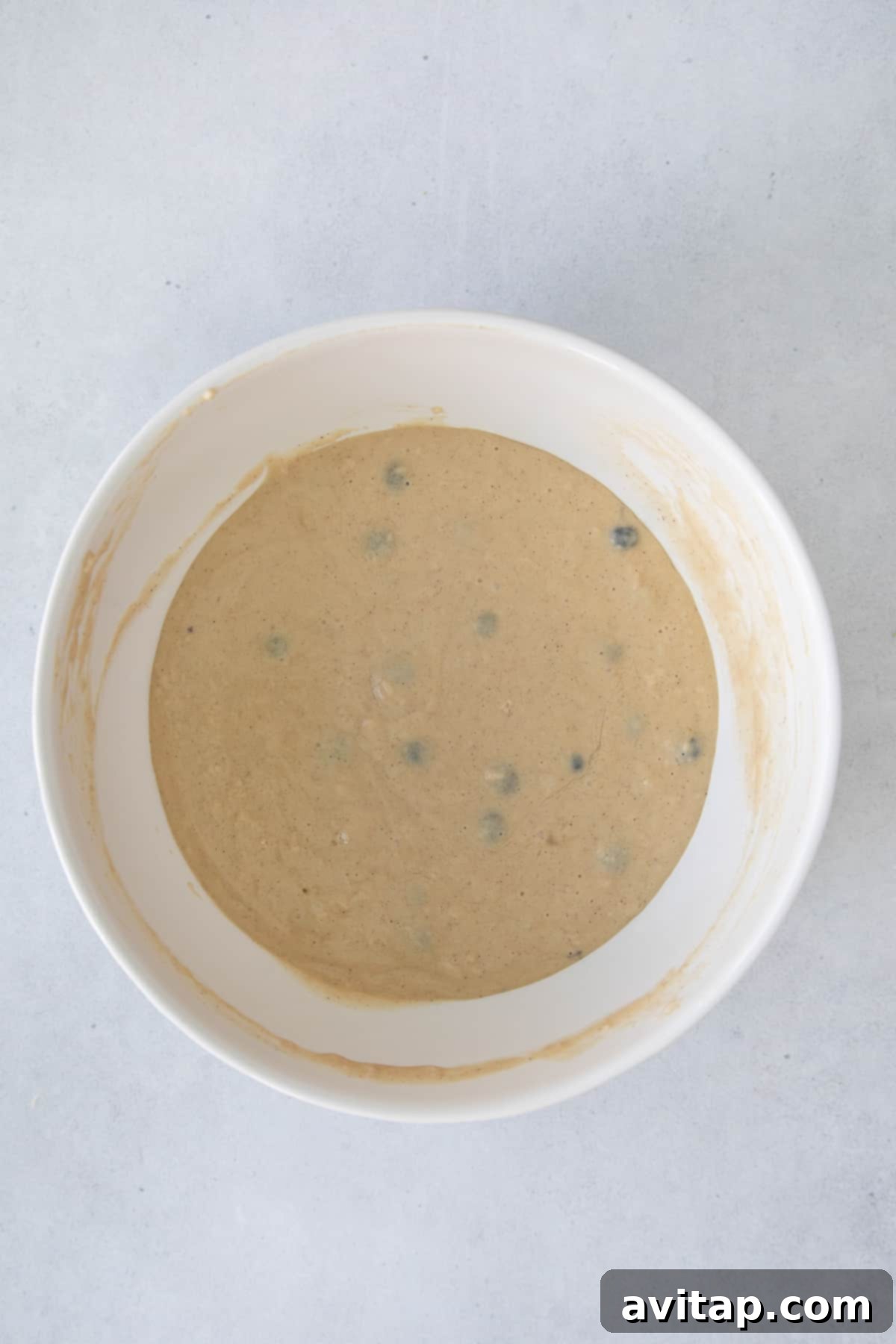 Thick, smooth pancake batter ready for baking in a mixing bowl.