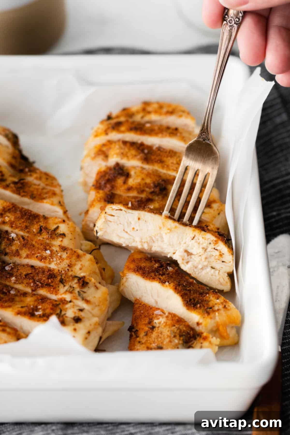 Serving dish filled with tender, juicy air fryer chicken breast.